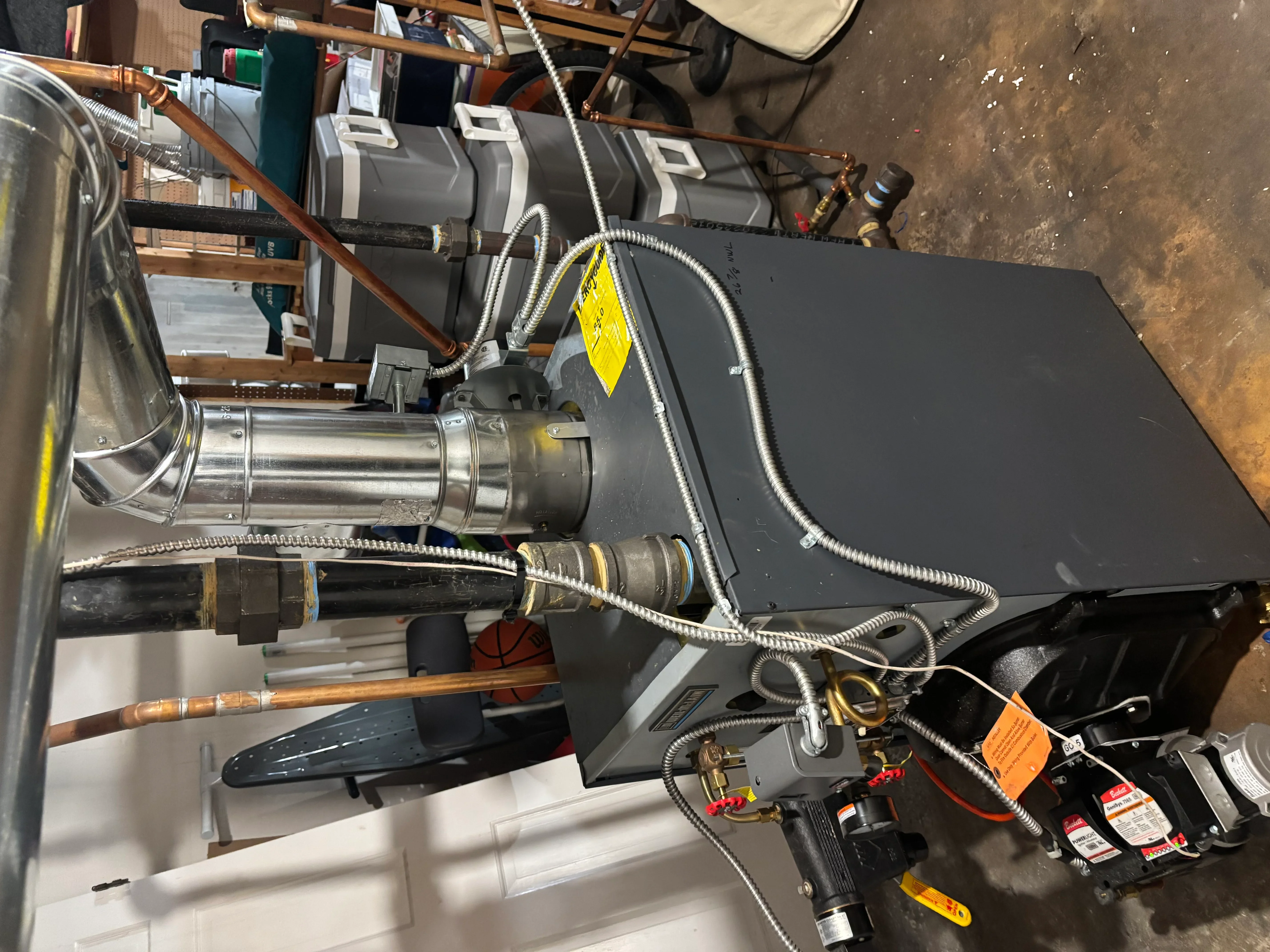Tankless water heater installation with copper piping and brass fittings